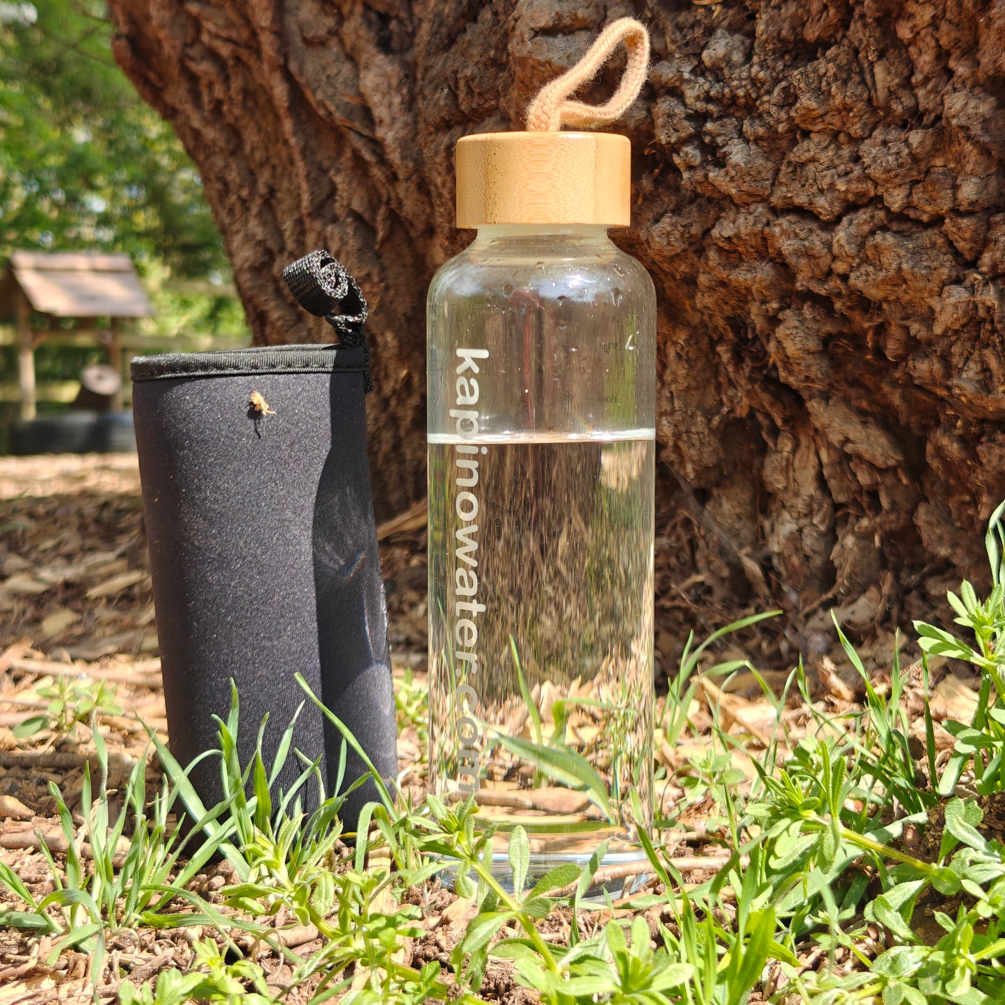 500ml glass bottle with protective black sleeve and bamboo swing lid.